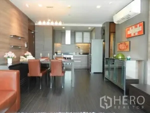 Condominium for rent in Watthana, Bangkok - Open-plan living and dining room with floor-to-ceiling windows, modern lighting and city views.