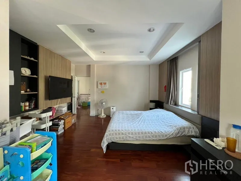 Detached House for rent or sale in Saphan Sung, Bangkok - Master bedroom alternate angle showing bed, built-ins and tray ceiling.