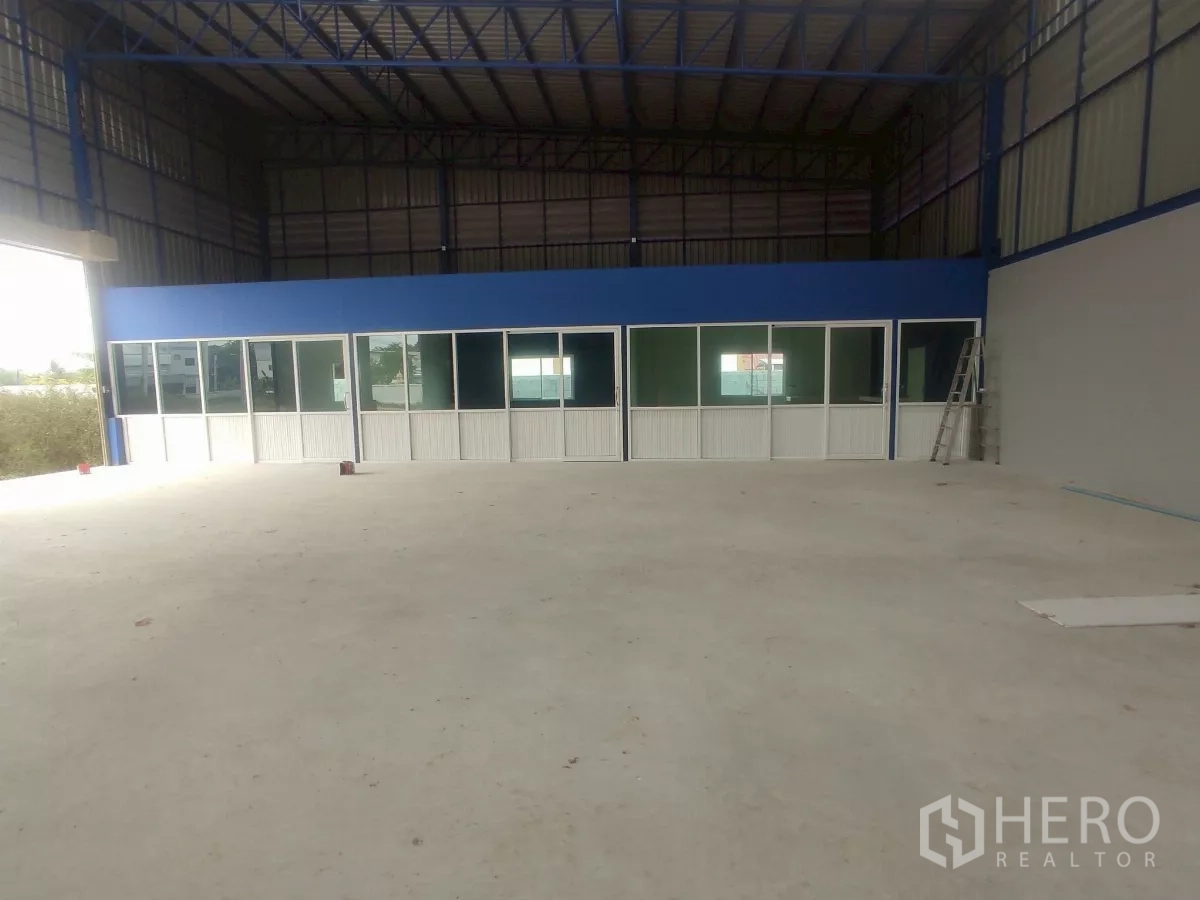 Factory for sale in Khlong Toei, Bangkok - Internal office block with glass windows and doors inside the warehouse.