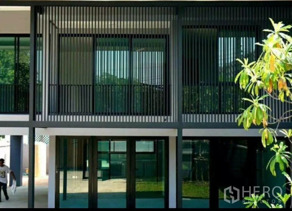 Home Office for rent in Lat Phrao, Bangkok - Modern balcony with black vertical slats shading full-height second-floor windows.