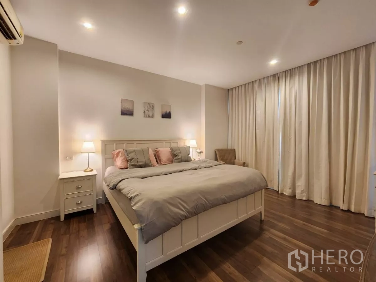 Condominium for rent in Phra Khanong, Bangkok - Wide master bedroom with large windows and soft lighting.