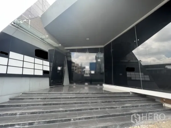 Retail Space for rent in Sathon, Bangkok - Main entrance steps leading to full-height glass doors beneath a cantilevered canopy.