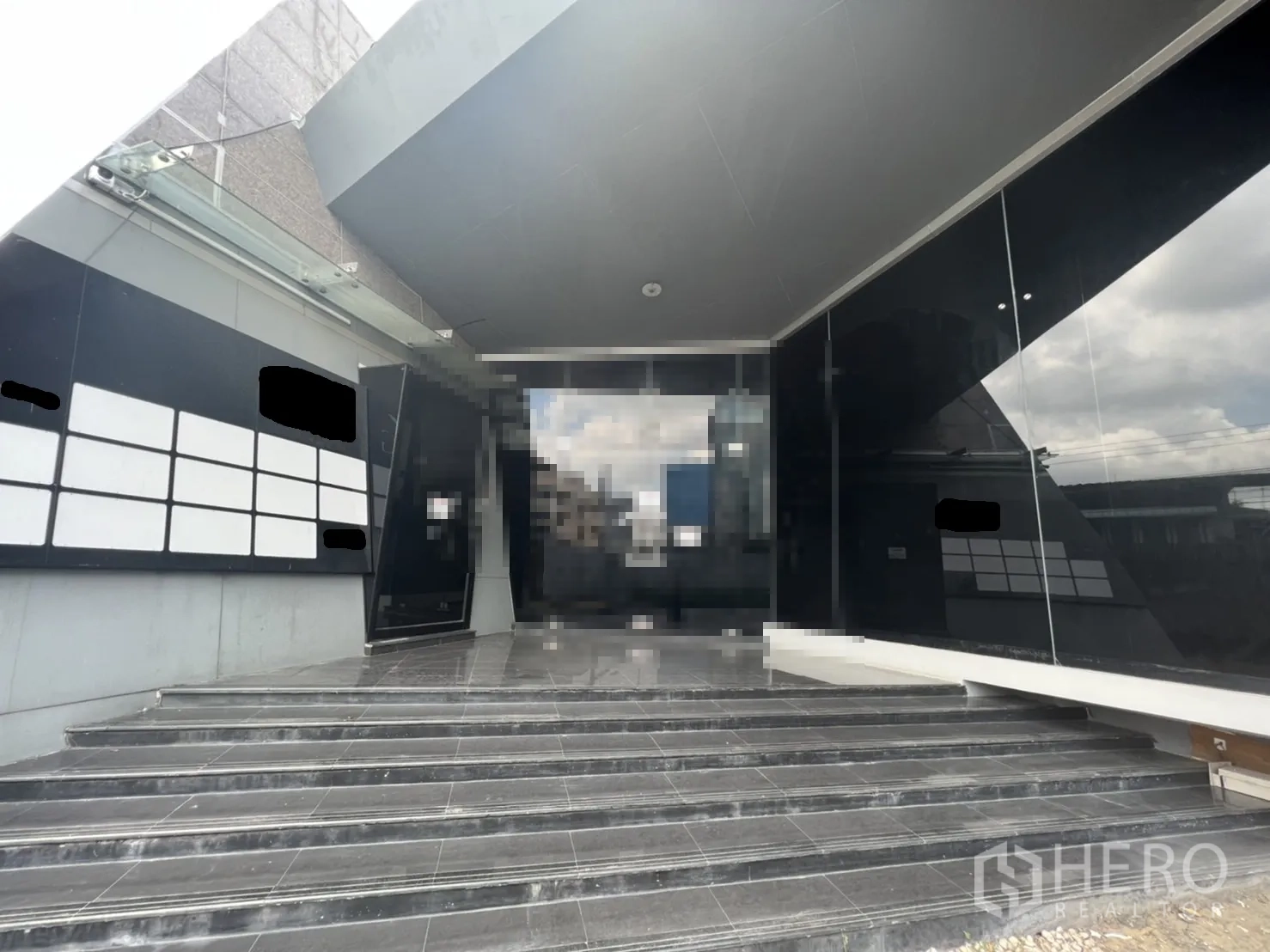 Retail Space for rent in Sathon, Bangkok - Main entrance steps leading to full-height glass doors beneath a cantilevered canopy.