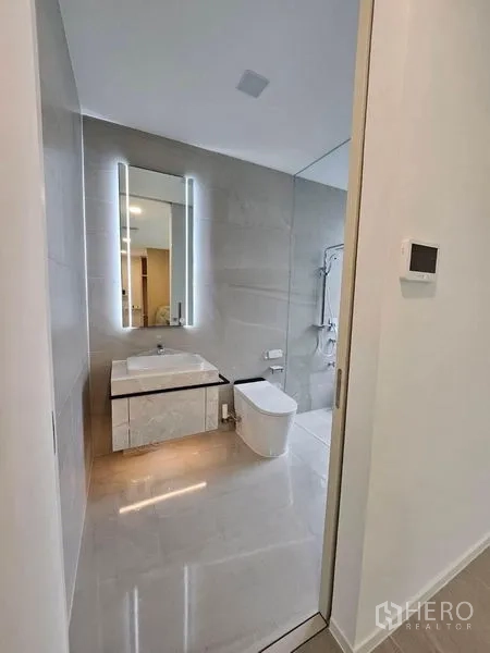 Detached House for rent - Contemporary guest bathroom with illuminated mirror, vanity and toilet.