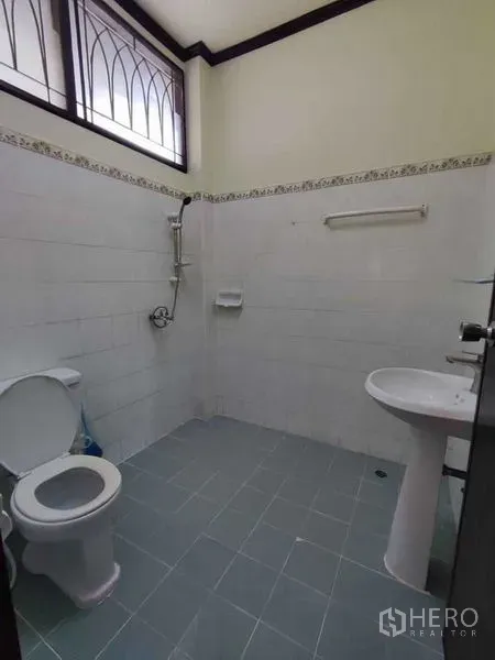 独立式住宅 出租在Khlong Toei, Bangkok - 简洁瓷砖卫浴，配马桶、淋浴和柱式洗手盆，带高窗采光。
