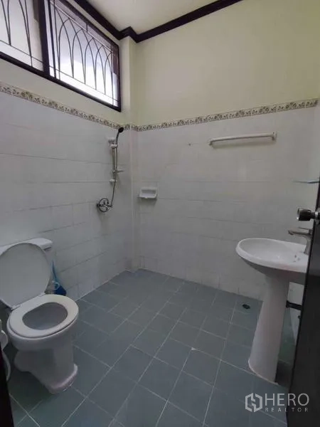 独立式住宅 出租在Khlong Toei, Bangkok - 简洁瓷砖卫浴，配马桶、淋浴和柱式洗手盆，带高窗采光。