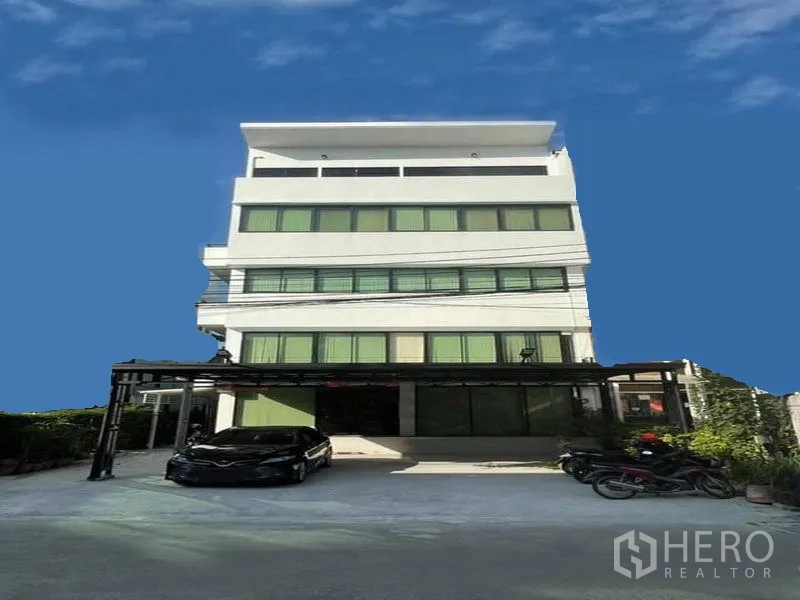 Office Space for rent in Suan Luang, Bangkok - Modern multi-storey office building exterior with on-site parking.