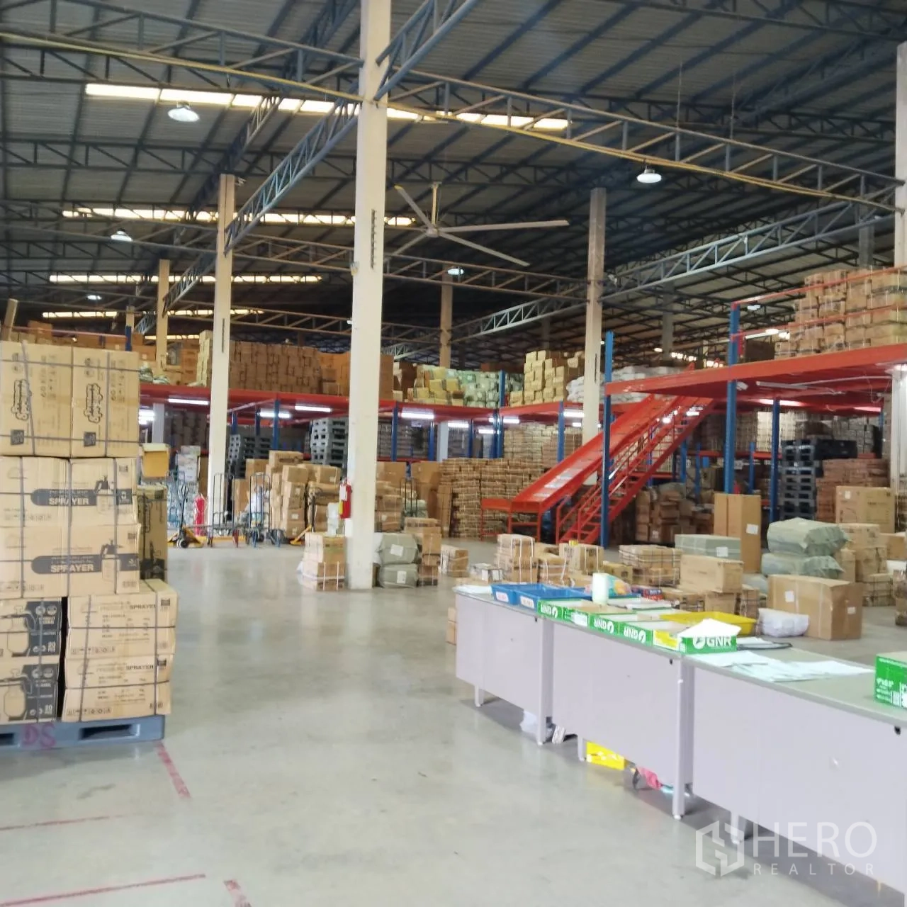 Warehouse for rent in Bang Khun Thian, Bangkok - Open warehouse floor with mezzanine storage and internal staircase.