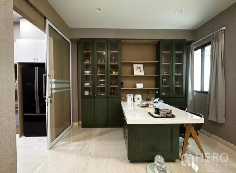 Townhouse for rent in Yan Nawa, Bangkok - Pantry view toward a sliding-door kitchen with floor-to-ceiling cabinets and island seating.