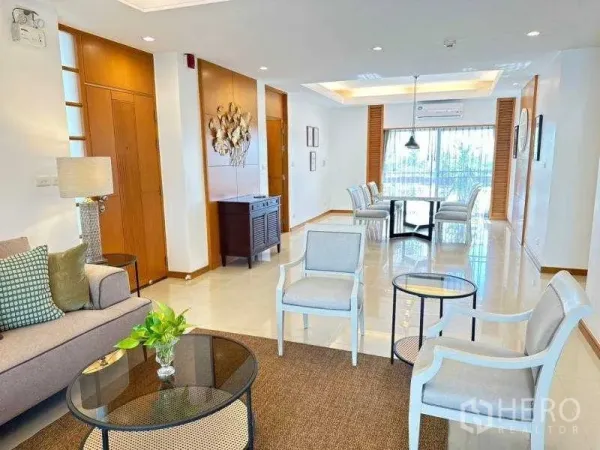 Apartment for rent - Bright open‑plan living and dining area with cove lighting, balcony doors and wood accents in a 3‑bedroom apartment in Sathon, Bangkok near MRT Lumphini.