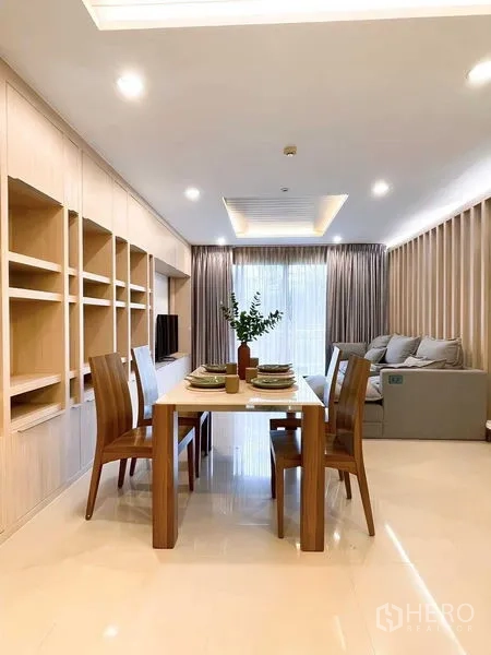 Condominium for rent - Open-plan dining and living space facing full-height glass and curtains.