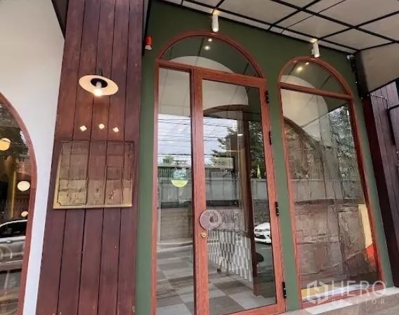 Retail Space for rent in Watthana, Bangkok - Inviting arched glass entry with wood trim and exterior sconce.