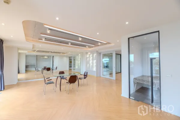 Office Space for rent in Wang Thonglang, Bangkok - Bright open-plan meeting space with glass partitions and decorative ceiling lights.