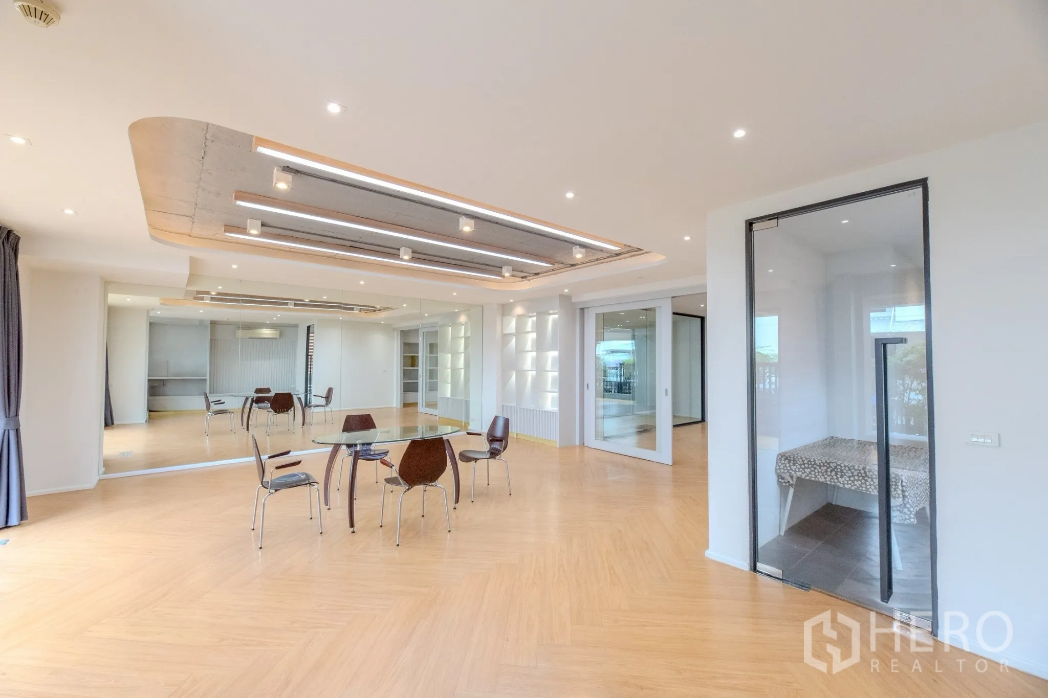 Office Space for rent in Wang Thonglang, Bangkok - Bright open-plan meeting space with glass partitions and decorative ceiling lights.