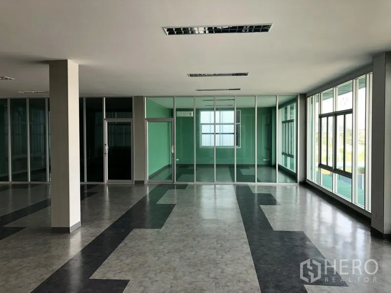 Factory for rent or sale in Bang Phli, Samut Prakan - Bright office level with floor-to-ceiling glass meeting rooms and large windows.