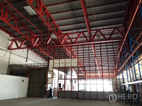 Warehouse for rent in Bang Na, Bangkok - Glass-partition internal office inside warehouse under red steel truss roof.
