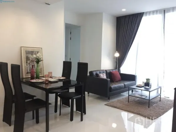 Condominium for rent or sale in Sathon, Bangkok - Bright open-plan living and dining area with black leather sofa, four-seat table, and floor-to-ceiling windows in a Sathon condo.