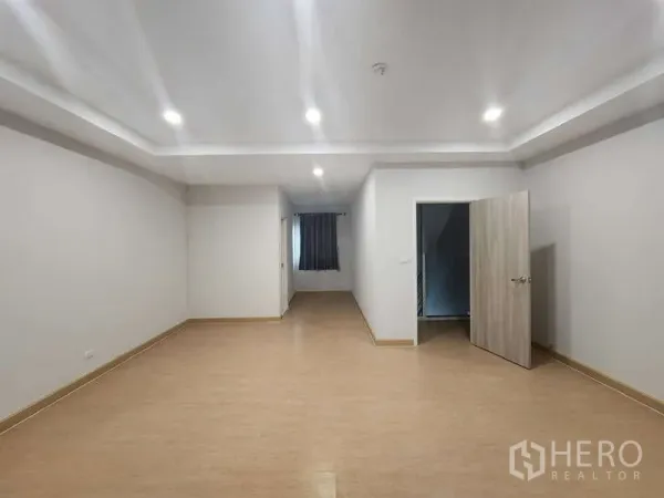 Home Office for rent in Lat Krabang, Bangkok - Spacious room with recessed lighting, wood-style flooring and doorway to stairs.