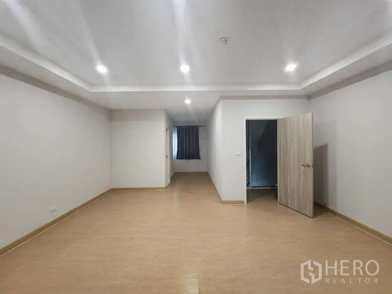 Home Office for rent in Lat Krabang, Bangkok - Spacious room with recessed lighting, wood-style flooring and doorway to stairs.