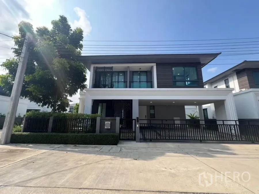 Detached House for rent or sale - Front elevation of the house with fence and neat hedges under blue sky.