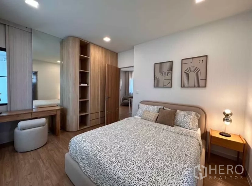 Detached House for rent in Samut Prakan - Spacious bedroom with wood cabinetry, vanity corner, and soft lighting.