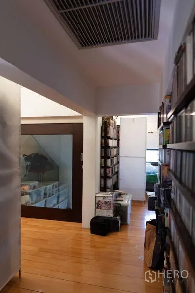 Townhouse for sale - Upper hallway with wooden flooring and built‑in shelving.