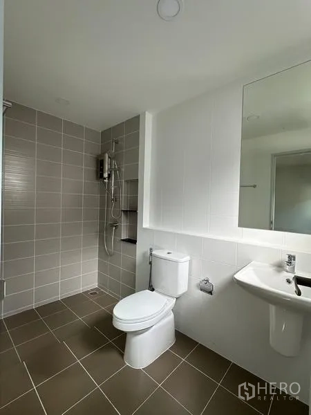 Detached House for sale in Nonthaburi - Tiled bathroom featuring a walk-in shower, toilet, sink and large mirror.