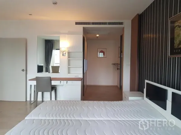Condominium for rent in Khlong Toei, Bangkok - Master bedroom view showing built-in desk, shelves and wardrobe.