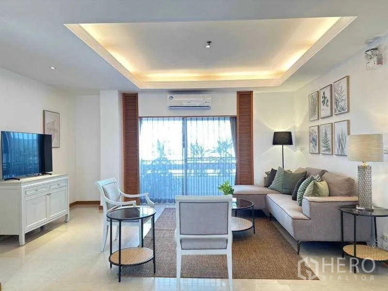 Apartment for rent - Living room facing large sliding doors, cove ceiling lighting and sectional sofa.