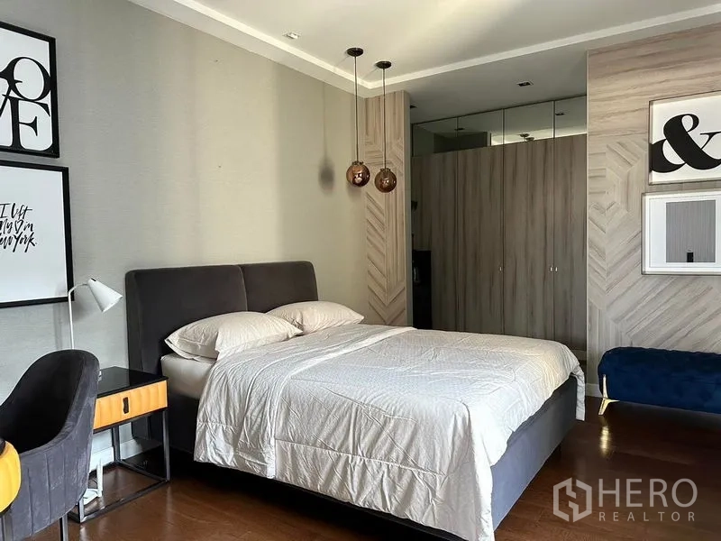 Detached House for rent in Phra Khanong, Bangkok - Bright bedroom with built-in wardrobes, pendant lights, and a work desk.