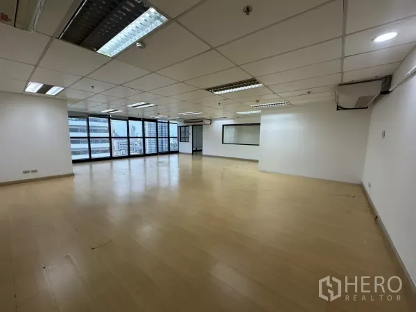 Office Space for rent in Watthana, Bangkok - Spacious office facing city views with split-type air conditioners and a glass partition.