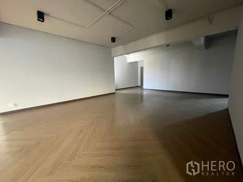 Home Office for rent in Phaya Thai, Bangkok - Angle view of an open room featuring herringbone flooring and exposed ceiling services.