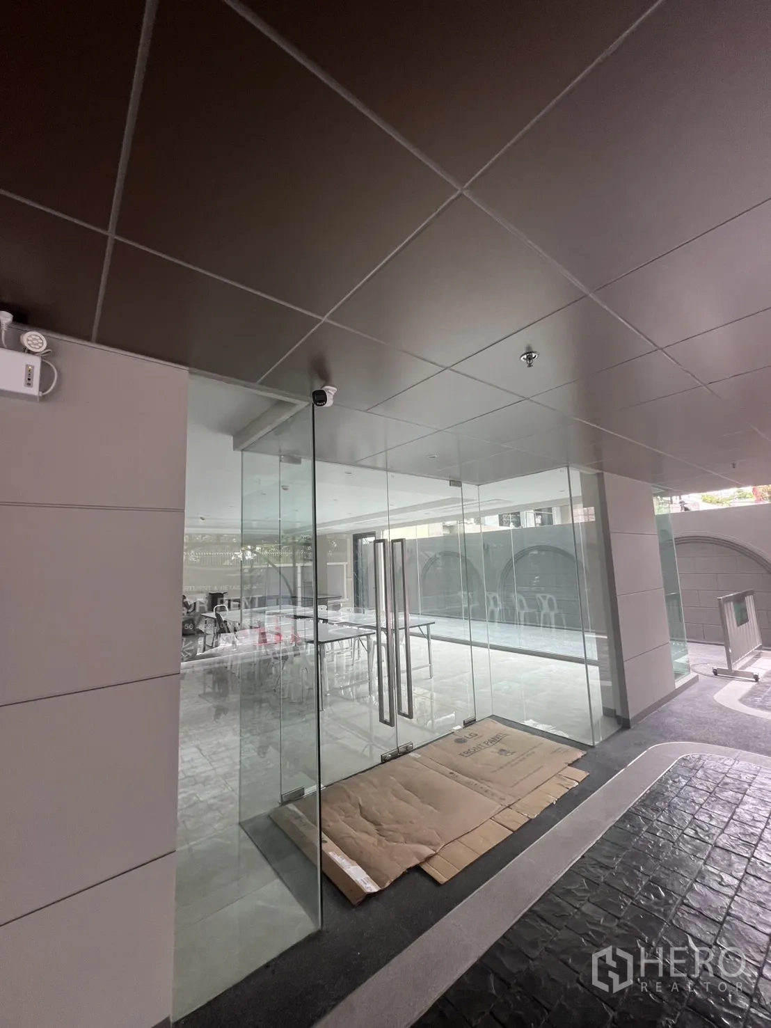 Retail Space for rent in Watthana, Bangkok - Double glass-door entrance to the retail unit under a modern ceiling with CCTV.