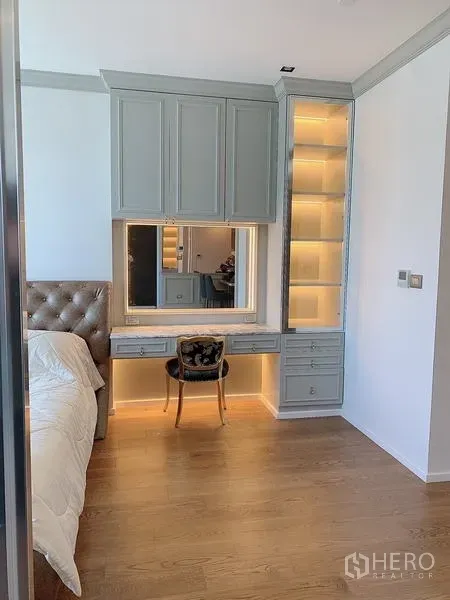 Condominium for sale - Close-up of custom built-in vanity and illuminated shelving in the bedroom.