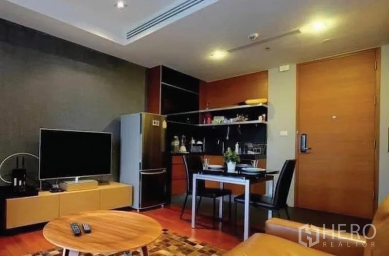 公寓 出售在Khlong Toei, Bangkok - 电视墙对面是用餐角与紧凑厨房，配大冰箱。
