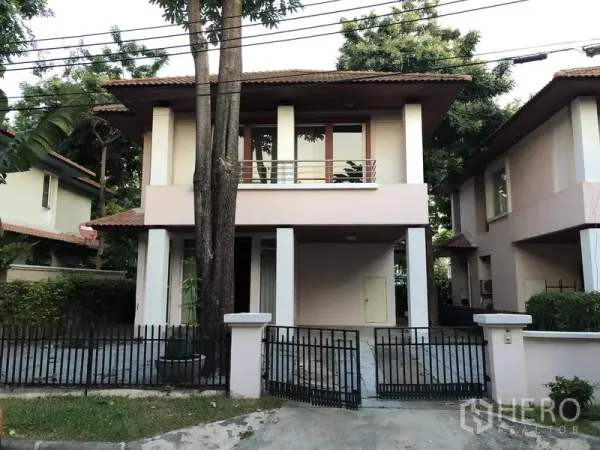 Detached House for rent in Wang Thonglang, Bangkok - Two-storey detached house with gated driveway, balcony, and mature trees.