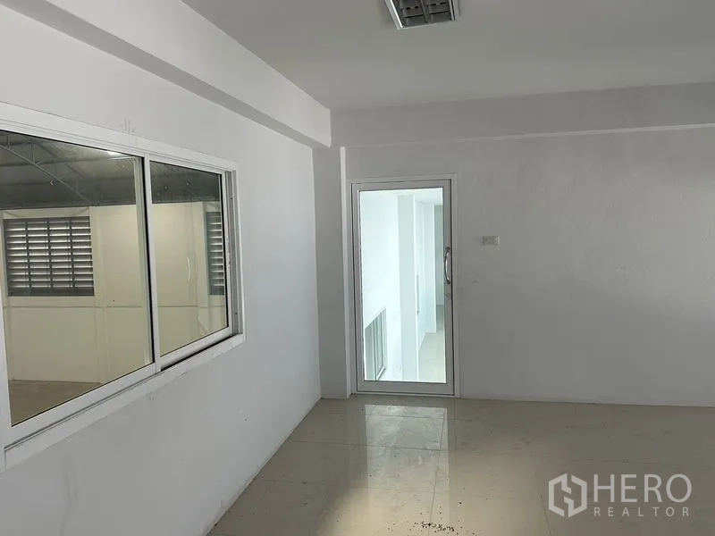 Factory for rent in Bang Bo, Samut Prakan - Private office room with window overlooking the warehouse and a glass door to the corridor.