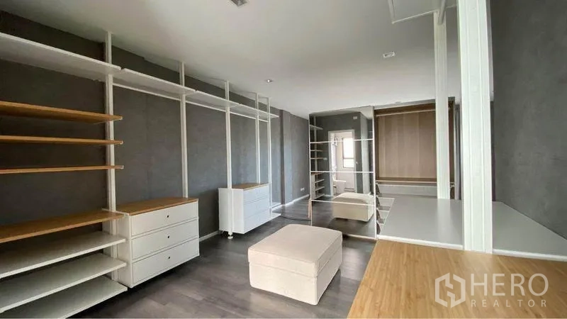 Retail Space for sale in Bang Na, Bangkok - Large display or storage room fitted with open shelving units, drawers and a central ottoman.