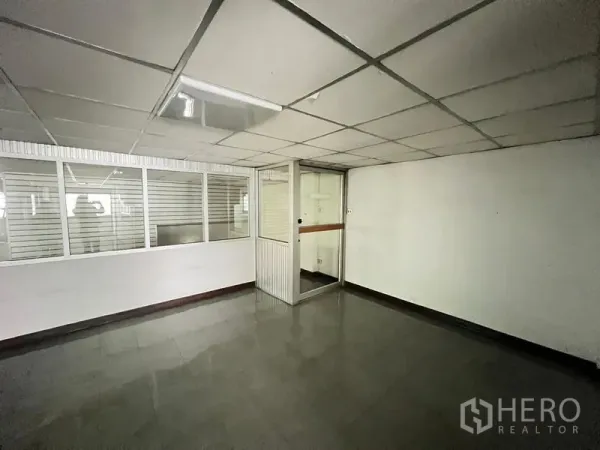 Shophouse for sale - Compact office room with glass partitions and tiled flooring.