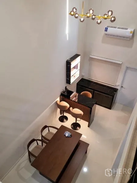 Townhouse for rent - View from mezzanine overlooking dining table and breakfast bar.