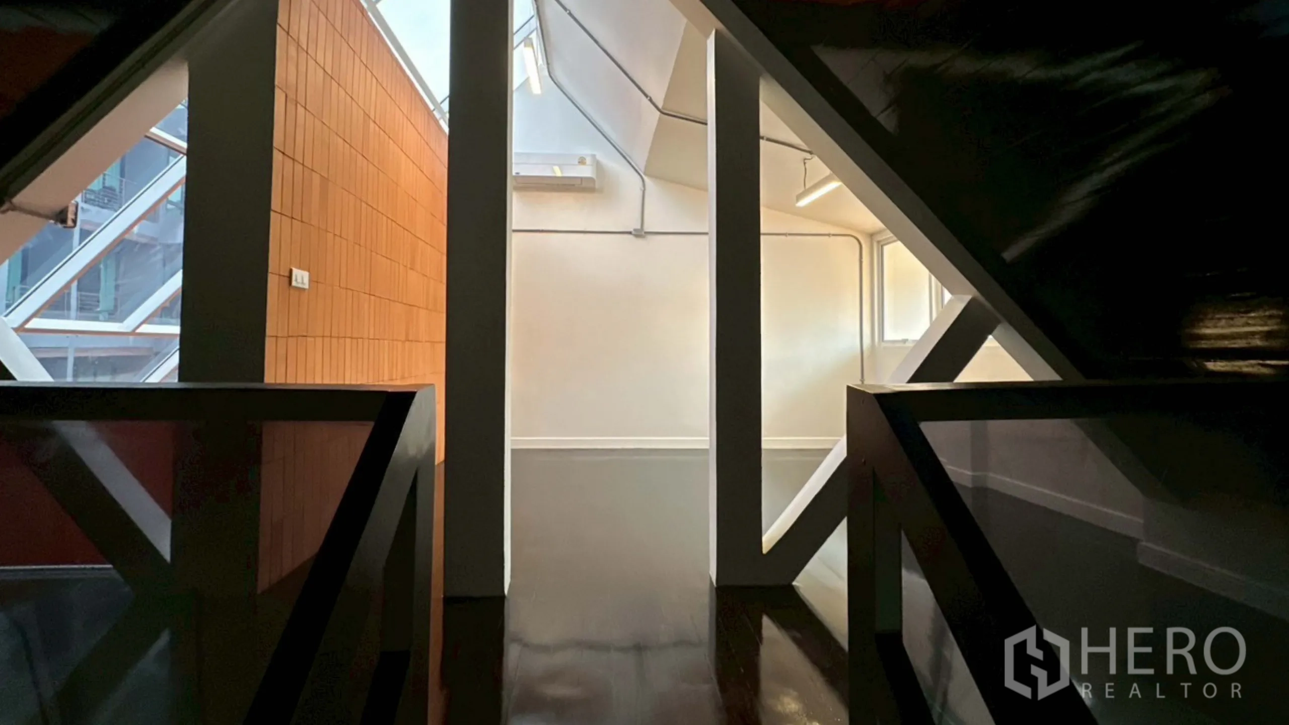 Home Office for rent in Watthana, Bangkok - Mezzanine walkway under pitched roof with beams and skylight.
