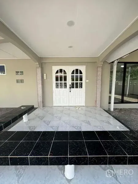 Detached House for rent in Wang Thonglang, Bangkok - Arched front porch featuring tiled steps and classic white double entry doors.