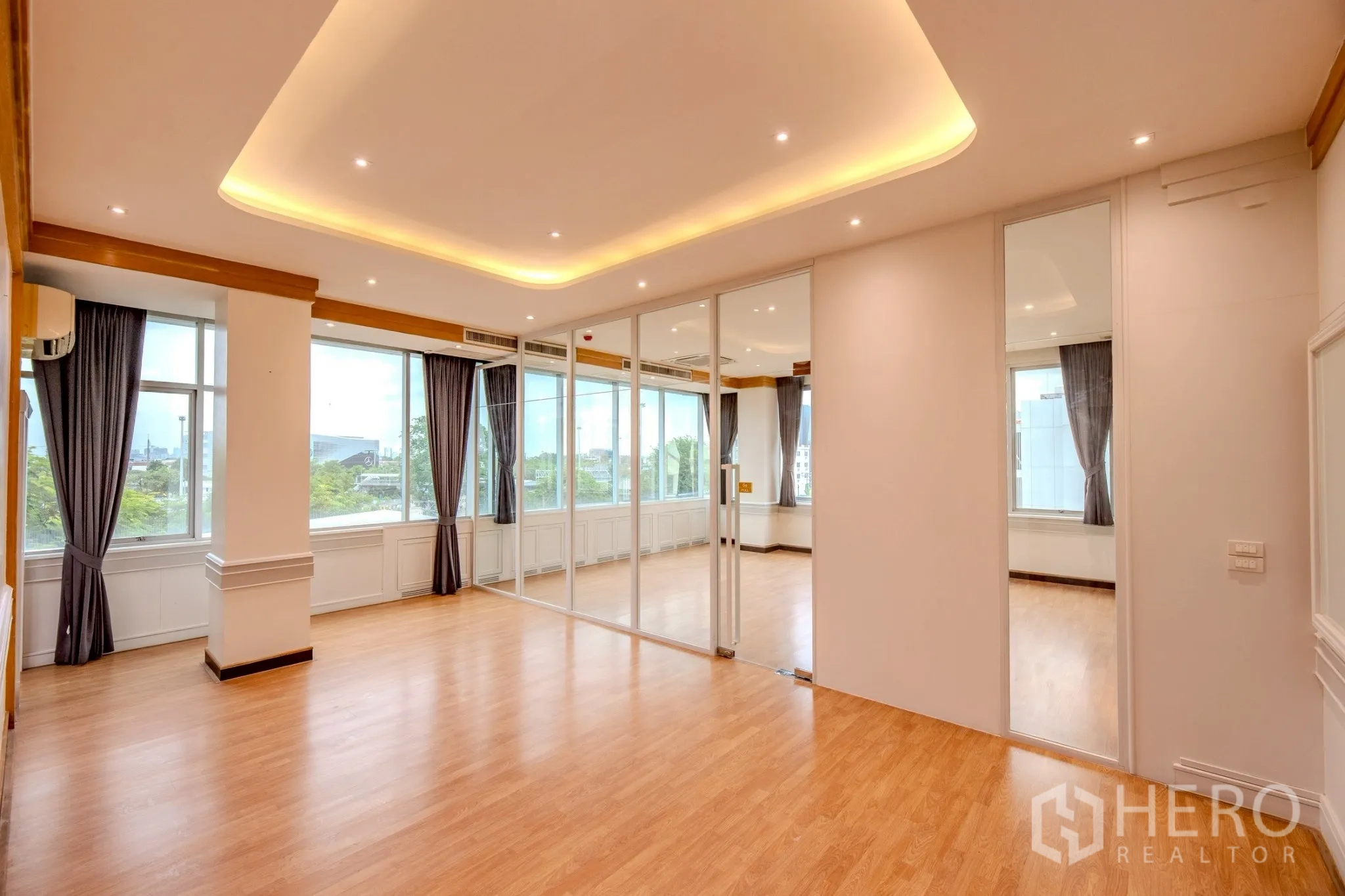 Office Space for rent in Wang Thonglang, Bangkok - Corner office room with full-height windows, curtains and sliding glass door.