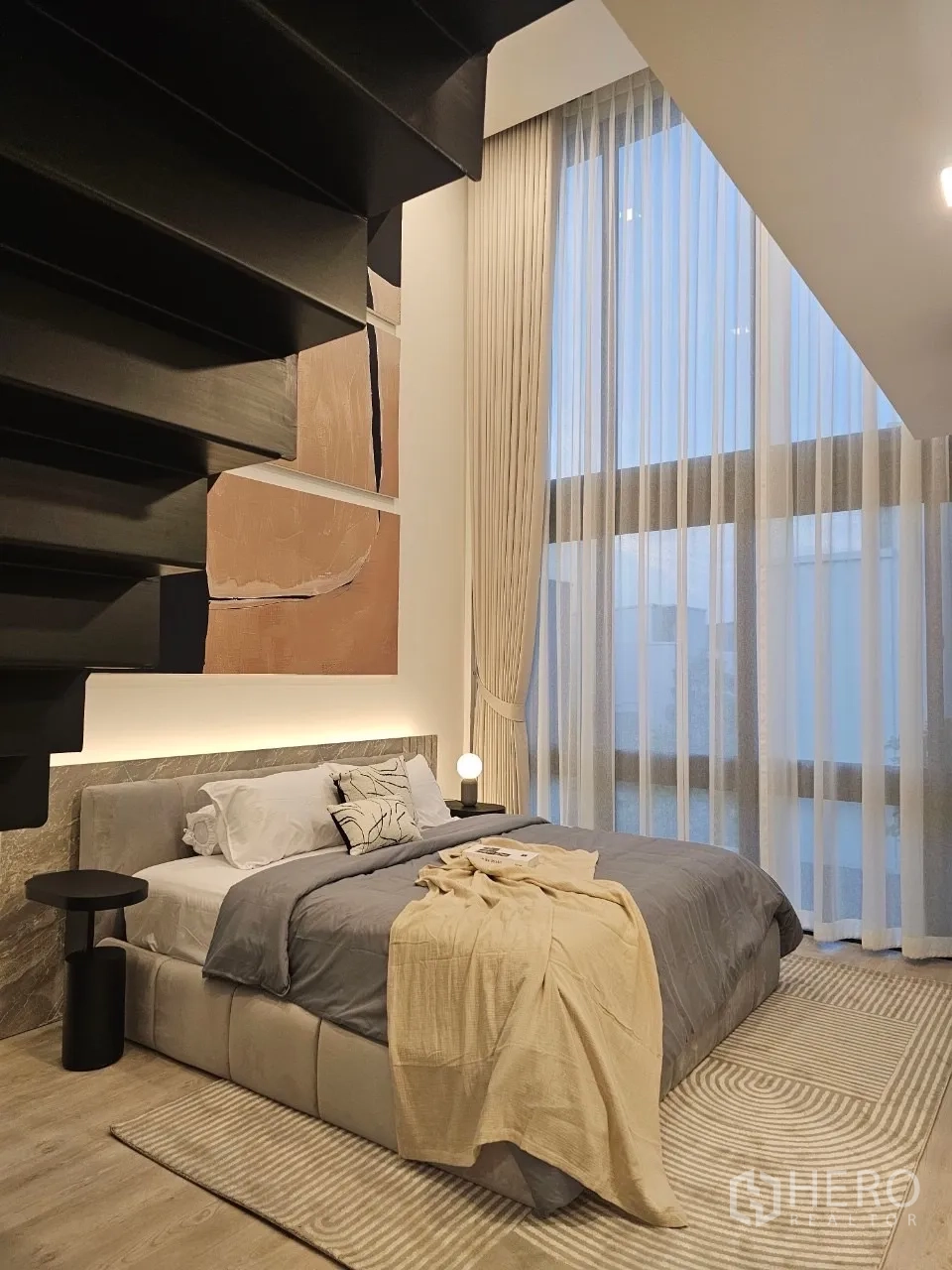 Detached House for rent in Saphan Sung, Bangkok - Double-height bedroom with mezzanine loft, tall curtains and modern staircase.