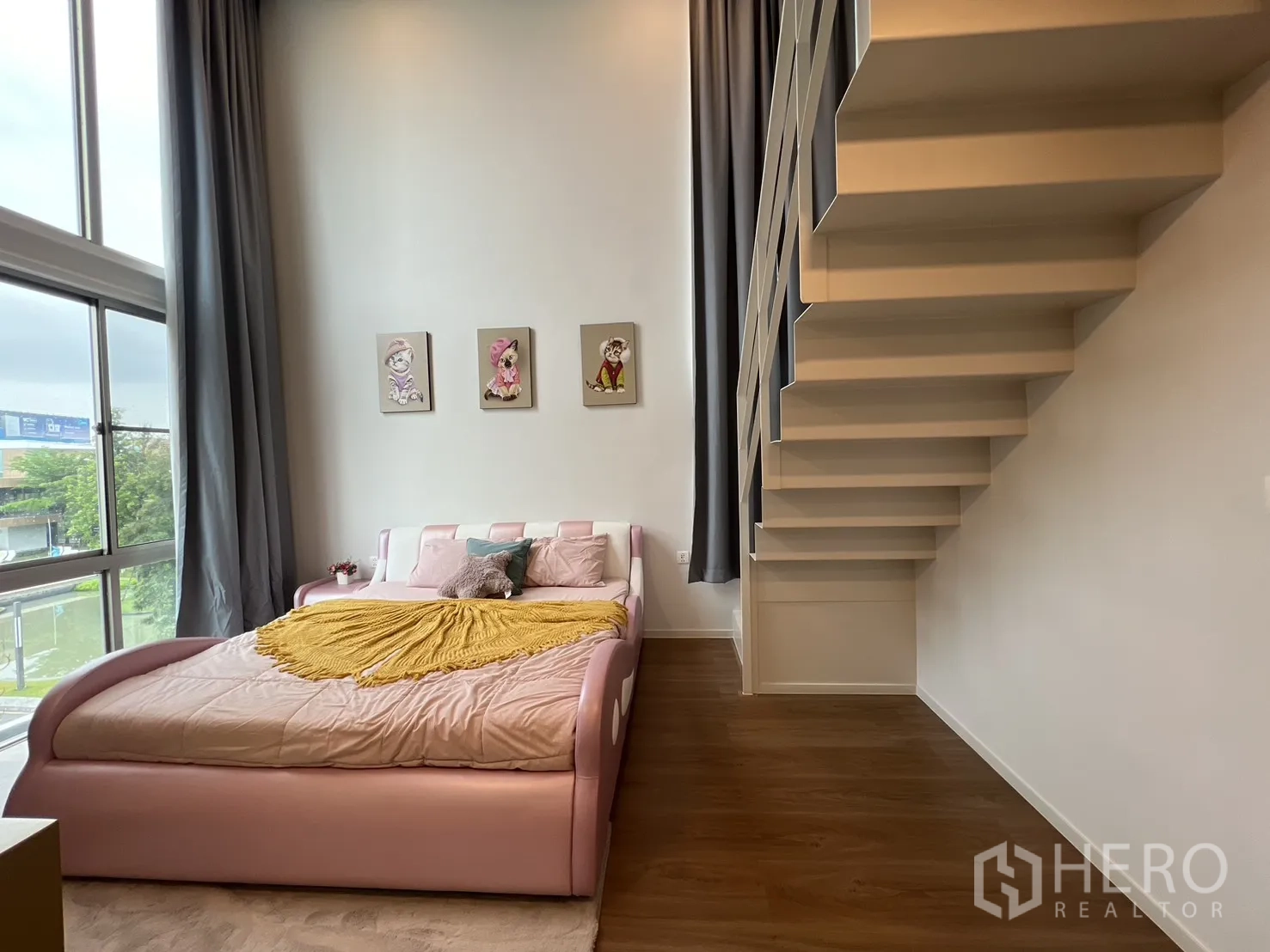 Detached House for rent in Saphan Sung, Bangkok - Bright loft bedroom with large windows and wall art.