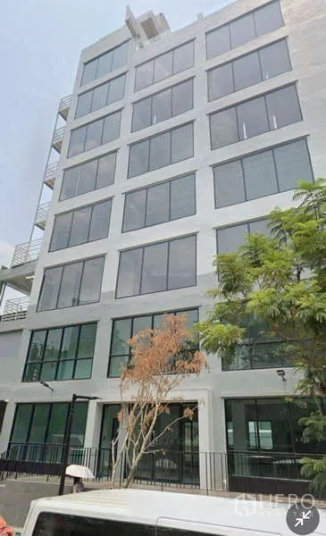 Office Space for rent in Bang Rak, Bangkok - Exterior view of the upgraded office building with uniform large windows.
