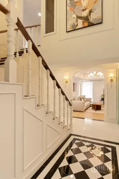 Condominium for sale in Watthana, Bangkok - Classic staircase in Watthana condominium with white balusters and black-and-white marble floor.