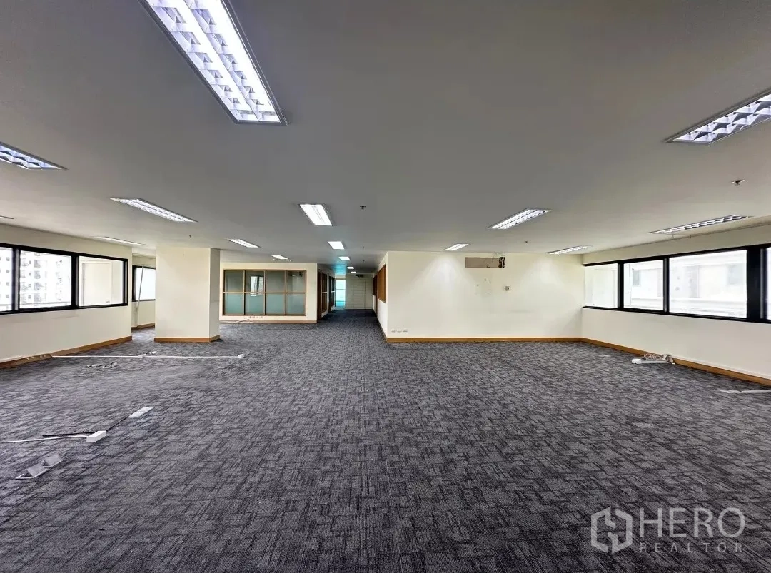 Office Space for rent in Bang Rak, Bangkok - Expansive full-floor office with windows on both sides and glass-walled rooms.