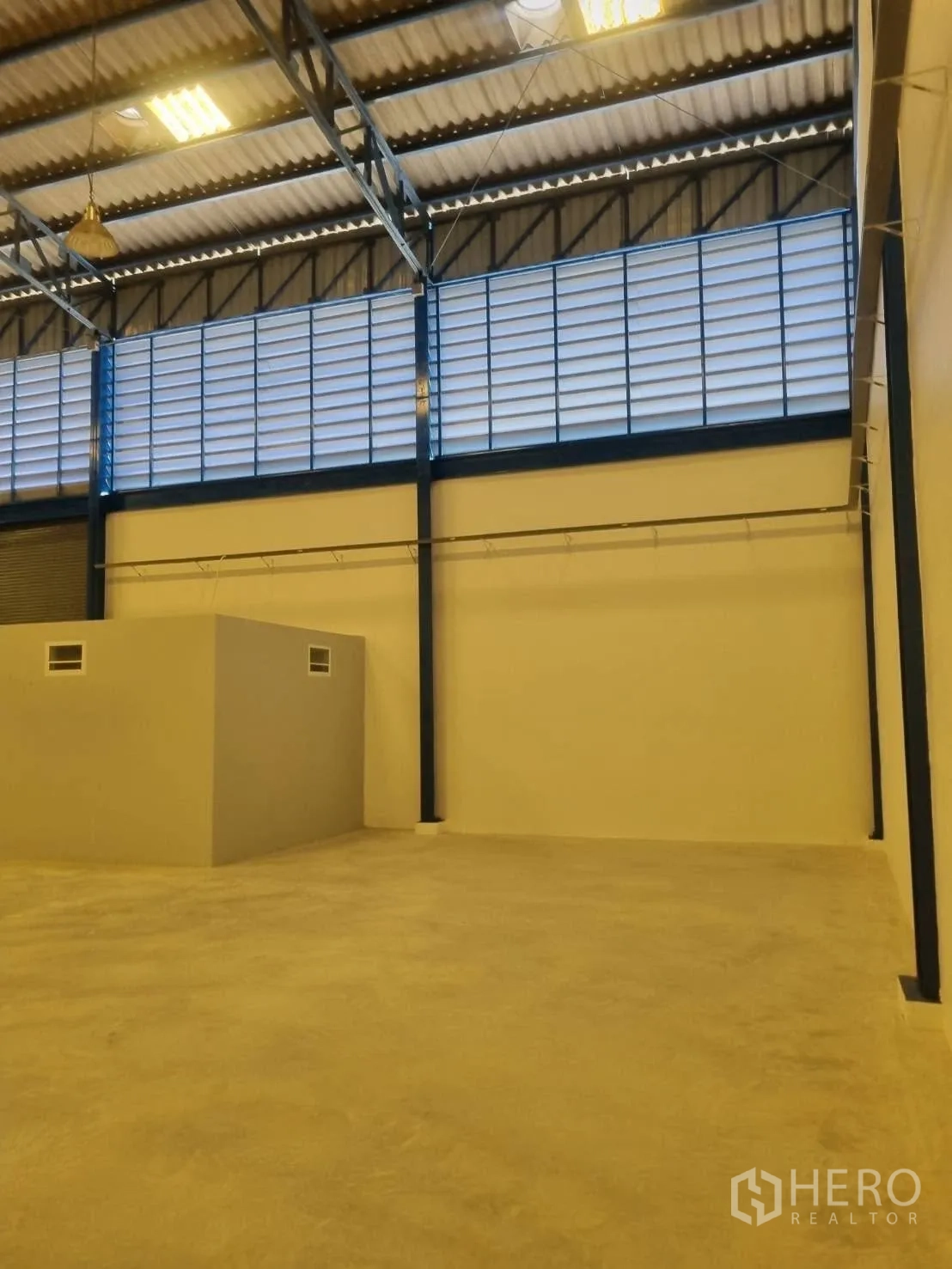 仓库 for rent in Thepharak, Nakhon Ratchasima - 仓库内部高屋顶、百叶通风窗与混凝土地面。
