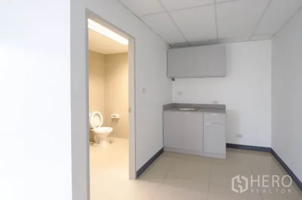 Office Space for rent in Suan Luang, Bangkok - Bright corner of the office with broad windows and an internal door.